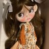 Blythe doll has long curly brown hair