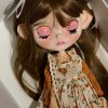 Blythe doll has long curly brown hair
