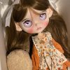 Blythe doll has long curly brown hair