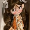 Blythe doll has long curly brown hair